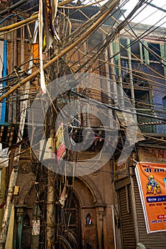 Chaotic electrical wires in an old Indian city center. Connected cables mess