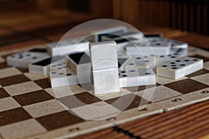 Chaotic pile of domino pieces on the bamboo brown wooden table background