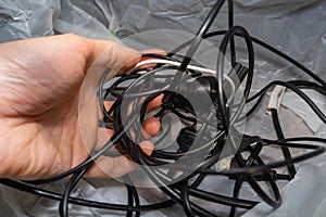 a chaotic pile of wires and cables in your hand. The problem of storing cables and charging cords