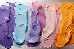 Chaotic strokes of oil paint of different colors on white paper, abstract multi-colored background