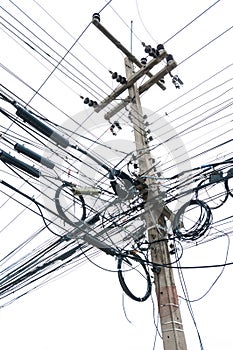 Chaotic tangle of wires on electric post photo