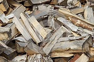 Chaotically scattered birch wood in a pile