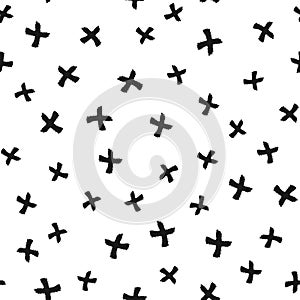 Chaotically scattered black crosses drawn by hand with a rough brush. Isolated on white background. Modern seamless pattern.