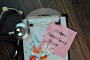 Chapare Hemorrhagic Fever write on sticky notes isolated on Wooden Table. Medical or Healthcare concept