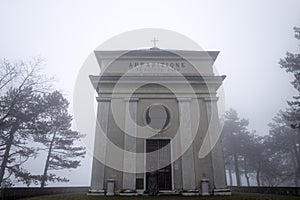 Chapel of the appearace near the Sanctuary of Our Lady of the Guard in the fog, in winter time, in Genoa,