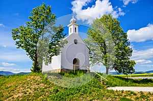 Chapel in beautiful sunny spring day - green trees and clear blue sky