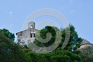 Chapel behind green trees