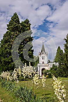 Chapel with bell tower among the trees in the park