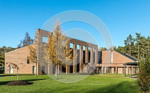 Chapel and crematorium in Oddernes, Kristiansand, with trees, grass and blue sky in autumn, Kristiansand, Norway