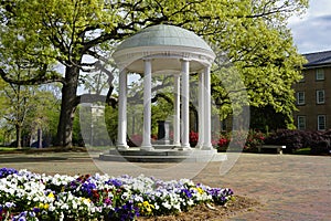 Chapel Hill, NC / USA - April 10, 2021: Flowers around the Old Well on the campus of the University of North Carolina