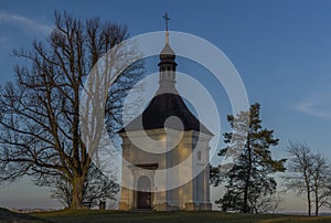 Chapel on hill over Trebic town in Moravia region in sunset evening