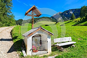 Chapel on path in Dolomites Mountains in summer, Italy