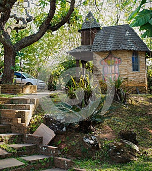 Chapel of prayers, next to large trees, in a public park.