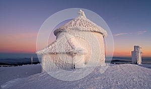 chapel on Sniezka peak during sunset in winter time in Giant mountains
