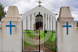 chapel sra das Neves with iron gate.2 blue crucifixes on the side pillars.  Castelo Branco District