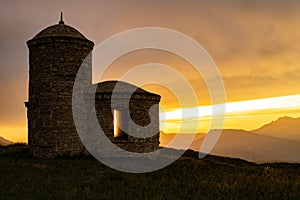 chapel at sunset in the mountains