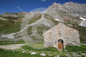A chapel surrounded by mountains, located next to Roc de la Peche hut photo
