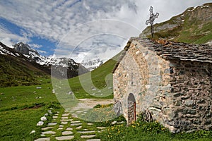 A chapel surrounded by mountains, located next to Roc de la Peche hut photo