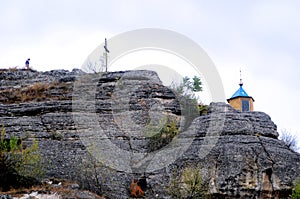 Chapel on top and wooden cross on a mountaintop