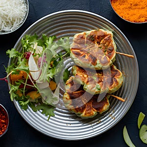 Chapli kabab served with fresh salad, a classic Indian dish