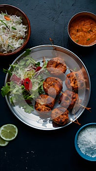 Chapli kabab served with fresh salad, a classic Indian dish