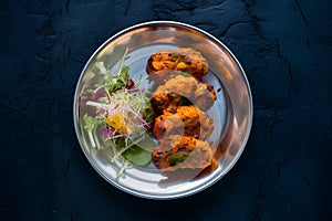 Chapli kabab served with fresh salad, a classic Indian dish