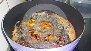 Chapli Kebab frying in the oil, a closeup view