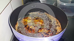 Chapli Kebab frying in the oil, a closeup view
