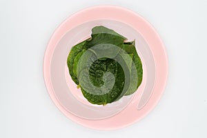 Chaplo leaves in pink dish on white background