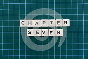 Chapter seven word made of square letter word on green square mat background