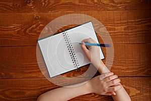 Character Child Writing in Blank Notebook Flat Lay