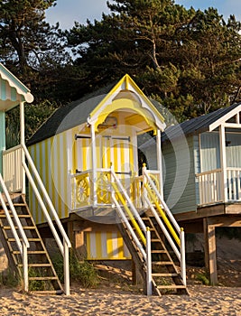Characterful, yellow beach hut on the sea front at Wells-next-the-Sea, North Norfolk UK. Photographed at golden hour.