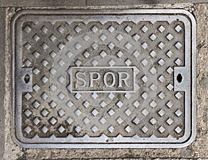 Characteristic iron manhole cover in the streets of the city of Rome
