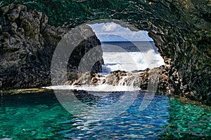 Charco azul volcanic cavern, natural volcanic ocean pool with turquoise ocean water in a volcanic cavern