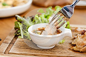 Charcoal-boiled Pork Neck with the Sauce is Spicy Sour Taste is a Popular Appetizer in Thailand. Grilled pork steak thai