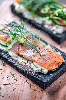 Charcoal Bread Smoked Salmon Sandwiches on wood board