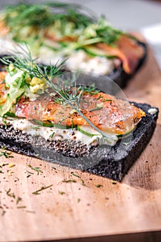 Charcoal Bread Smoked Salmon Sandwiches on wood board