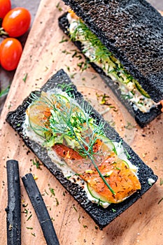 Charcoal Bread Smoked Salmon Sandwiches on wood board