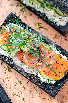 Charcoal Bread Smoked Salmon Sandwiches on wood board