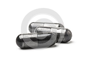 Charcoal capsule isolated on white background