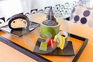 Charcoal vanilla soft cream with roll cake and fruit platter.