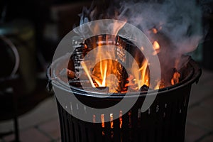 charcoals burning in a chimney starter in night