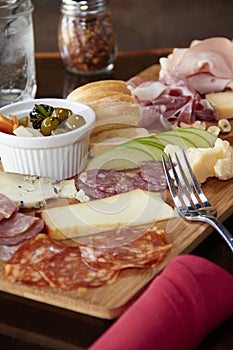 Charcuterie board with bread, meat, fruits