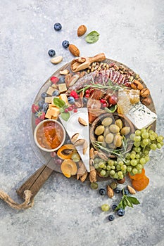 Charcuterie board. Cheese platter. Assortment of tasty appetizers or antipasti. Top view. Copy space