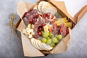Charcuterie board in a box with cheese and meat photo