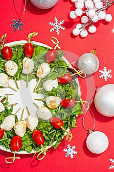 Charcuterie wreath in traditional New Year color design with Christmas decorations. Modern snack