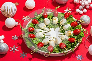 Charcuterie wreath in traditional New Year color design with Christmas decorations. Modern snack