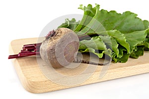 Chard with leaves and beetroots on soup on cutting board