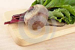 Chard with leaves and beetroots on soup on cutting board