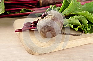 Chard with leaves and beetroots on soup on cutting board